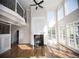 Sun-filled open living space with fireplace, soaring ceilings, and large windows at 2328 New Haven Pl, Conyers, GA 30094