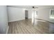 Bright living room featuring new flooring, ample natural light from large windows, and a ceiling fan at 2328 New Haven Pl, Conyers, GA 30094
