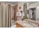 Well-lit bathroom features a shower-tub combo, granite countertop, and large mirror at 400 W Peachtree Nw St # 3114, Atlanta, GA 30308