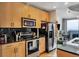 Modern kitchen featuring stainless steel appliances, black backsplash, and wood cabinets at 400 W Peachtree Nw St # 3114, Atlanta, GA 30308