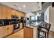 Contemporary kitchen with stainless steel appliances, granite countertops, and a breakfast bar overlooking city views at 400 W Peachtree Nw St # 3114, Atlanta, GA 30308