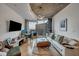 Cozy living room with neutral tones, a modern ceiling light, and large windows showcasing the city skyline at 400 W Peachtree Nw St # 3114, Atlanta, GA 30308