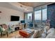 Living room with city views, modern decor, a work station, and a sliding glass door leading to a balcony at 400 W Peachtree Nw St # 3114, Atlanta, GA 30308