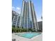 High-rise apartment building featuring an outdoor swimming pool and lounging area at 400 W Peachtree Nw St # 3114, Atlanta, GA 30308
