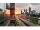 City skyline view at sunset showcasing a modern building with mirrored glass at 400 W Peachtree Nw St # 3114, Atlanta, GA 30308
