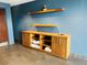 Bathroom storage area with wooden cabinets, floating shelves, and tile flooring at 400 W Peachtree Nw St # 3114, Atlanta, GA 30308