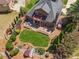 Aerial view of home with meticulously landscaped backyard, inviting patio, and a charming wooden bridge at 6382 Mountain Ridge Cir, Sugar Hill, GA 30518