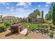 Expansive backyard featuring a wooden bridge, lush landscaping and a covered patio at 6382 Mountain Ridge Cir, Sugar Hill, GA 30518