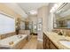 Bright bathroom showcasing granite countertops, a glass-enclosed shower, and a soaking tub at 6382 Mountain Ridge Cir, Sugar Hill, GA 30518
