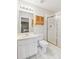 Bright bathroom with tiled shower, white sink and vanity with light wood cabinet at 6382 Mountain Ridge Cir, Sugar Hill, GA 30518