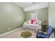 Cozy bedroom with daybed, throw pillows, and green carpet at 6382 Mountain Ridge Cir, Sugar Hill, GA 30518