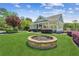 Well-manicured community clubhouse with an outdoor fire pit and an expansive lawn area at 6382 Mountain Ridge Cir, Sugar Hill, GA 30518