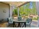 Cozy covered patio with outdoor seating, ceiling fan and serene backyard views at 6382 Mountain Ridge Cir, Sugar Hill, GA 30518