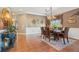 Elegant dining room with a decorative chandelier, wainscoting, and a large dining table at 6382 Mountain Ridge Cir, Sugar Hill, GA 30518