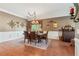 Formal dining room with a chandelier, wainscoting, and a wooden dining table set for six at 6382 Mountain Ridge Cir, Sugar Hill, GA 30518