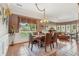 A formal dining area featuring a wood table, chandelier, and large window with decorative valance at 6382 Mountain Ridge Cir, Sugar Hill, GA 30518