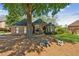 Single-story brick home with well-kept lawn, mature trees, and attractive landscaping at 6382 Mountain Ridge Cir, Sugar Hill, GA 30518