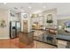 A well-lit kitchen featuring stainless steel appliances, a kitchen island, and sleek granite countertops at 6382 Mountain Ridge Cir, Sugar Hill, GA 30518
