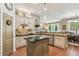 Bright kitchen featuring a kitchen island, stainless steel appliances, and views into a large back yard at 6382 Mountain Ridge Cir, Sugar Hill, GA 30518