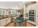 Bright, open kitchen featuring stainless steel appliances, granite countertops, and views into a large backyard at 6382 Mountain Ridge Cir, Sugar Hill, GA 30518