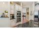 Bright kitchen showcasing stainless steel appliances, granite countertops, and custom white cabinets at 6382 Mountain Ridge Cir, Sugar Hill, GA 30518
