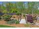 A quaint wooden bridge creates an inviting walkway through the professionally landscaped backyard at 6382 Mountain Ridge Cir, Sugar Hill, GA 30518
