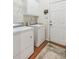 Laundry room with washer, dryer, white cabinets and access door at 6382 Mountain Ridge Cir, Sugar Hill, GA 30518