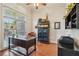 A cozy home office with a large window offering natural light and elegant dark wood furniture at 6382 Mountain Ridge Cir, Sugar Hill, GA 30518