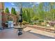Spacious outdoor patio featuring stainless steel grill and patio table at 6382 Mountain Ridge Cir, Sugar Hill, GA 30518