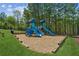 Community playground with slides and play structures, surrounded by green space and trees at 6382 Mountain Ridge Cir, Sugar Hill, GA 30518