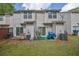 The exterior back of the townhouse has a sliding door to a patio with green space at 984 Redwood Dr, Norcross, GA 30093