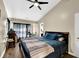 A bedroom featuring a ceiling fan, window with curtains, hardwood floors, and a full bed at 984 Redwood Dr, Norcross, GA 30093