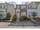 Charming two-story townhome featuring brick facade, grey shutters, and landscaped front yard at 984 Redwood Dr, Norcross, GA 30093