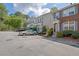 Well-maintained townhome complex with manicured landscaping and ample parking spaces at 984 Redwood Dr, Norcross, GA 30093