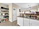 A kitchen featuring white cabinets, a pantry, and a sink with tiled backsplash and stone countertops at 984 Redwood Dr, Norcross, GA 30093