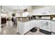A kitchen and breakfast bar featuring white cabinets, tiled backsplash, and stone countertops at 984 Redwood Dr, Norcross, GA 30093
