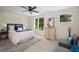 Bright bedroom featuring a ceiling fan, a large window with wooded views, and neutral decor at 1390 Stirling Nw Cir, Atlanta, GA 30318