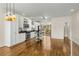 Well-lit kitchen open to a dining/living area, featuring stainless appliances, light cabinets and wood floors at 1390 Stirling Nw Cir, Atlanta, GA 30318
