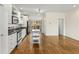 Open kitchen view with stainless appliances, light cabinets, kitchen island, and adjacent living area at 1390 Stirling Nw Cir, Atlanta, GA 30318
