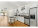 Contemporary kitchen with stainless steel appliances, light cabinets, kitchen island, and an adjacent living area at 1390 Stirling Nw Cir, Atlanta, GA 30318