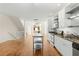 Modern kitchen view with stainless appliances, light cabinets, kitchen island, and an adjacent living area at 1390 Stirling Nw Cir, Atlanta, GA 30318
