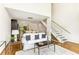 Living room with an open floor plan, a modern staircase, and hardwood floors at 1390 Stirling Nw Cir, Atlanta, GA 30318