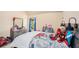 Bright bedroom features neutral walls, a fun comic-themed bedspread, and a window offering natural light at 143 Massey Ln, Locust Grove, GA 30248