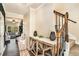 Inviting foyer featuring a staircase, stylish console table, and hardwood flooring at 143 Massey Ln, Locust Grove, GA 30248