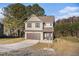 Attractive two-story brick home with attached garage and well-maintained lawn and landscaping at 143 Massey Ln, Locust Grove, GA 30248