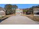 Charming two-story brick home featuring a spacious driveway and manicured front lawn at 143 Massey Ln, Locust Grove, GA 30248