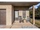 Inviting covered front porch featuring rocking chairs and classic brick facade at 143 Massey Ln, Locust Grove, GA 30248