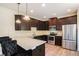 Beautiful kitchen features stainless steel appliances, dark cabinets, and granite counters at 143 Massey Ln, Locust Grove, GA 30248