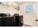 This practical laundry room has a window and modern washer and dryer machines at 143 Massey Ln, Locust Grove, GA 30248