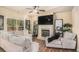 Cozy living room with fireplace, large TV, plush seating, and ample natural light at 143 Massey Ln, Locust Grove, GA 30248